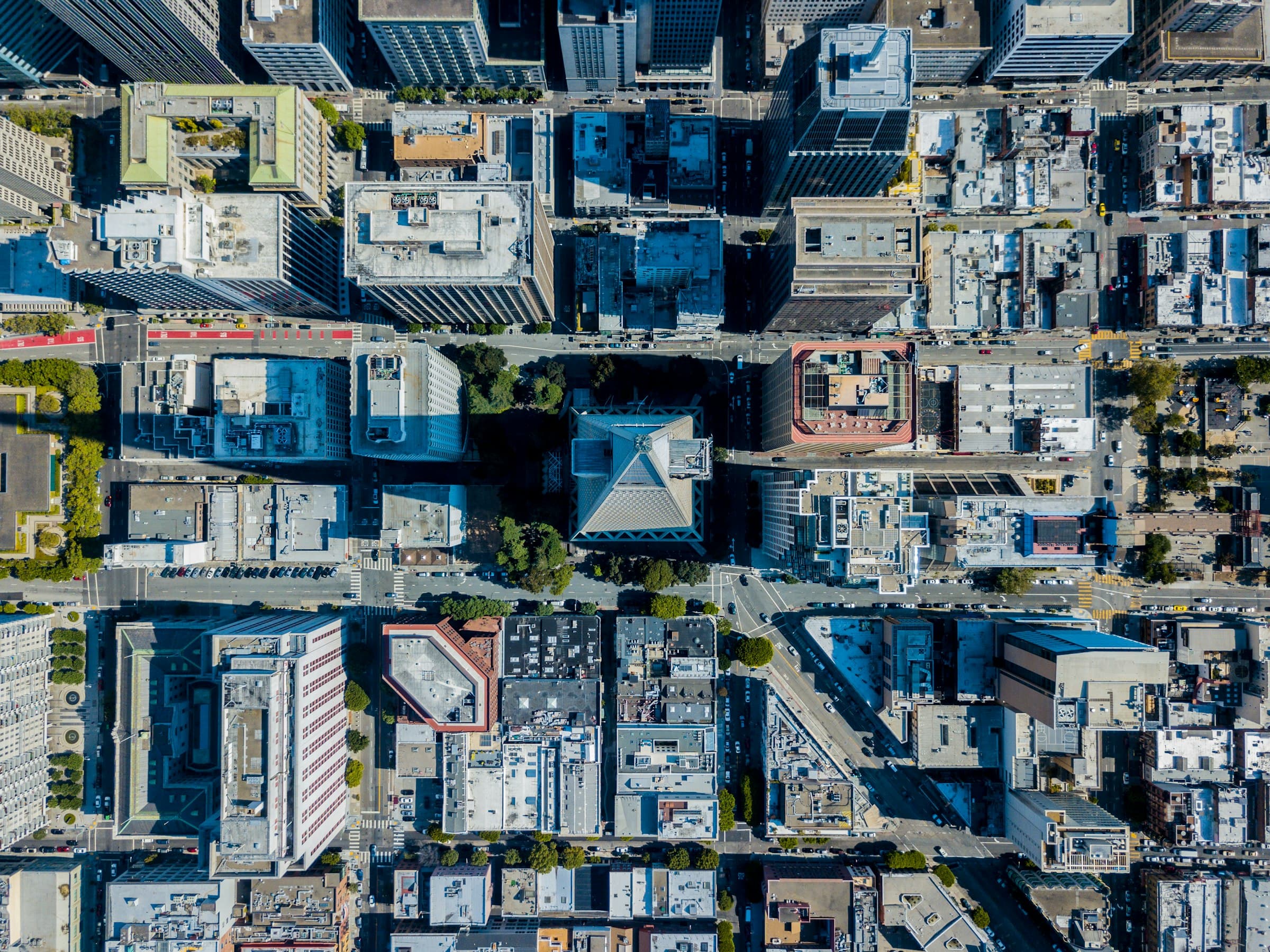 A city block pattern seen from directly above: rooftops, streets and courtyards in a regular grid.