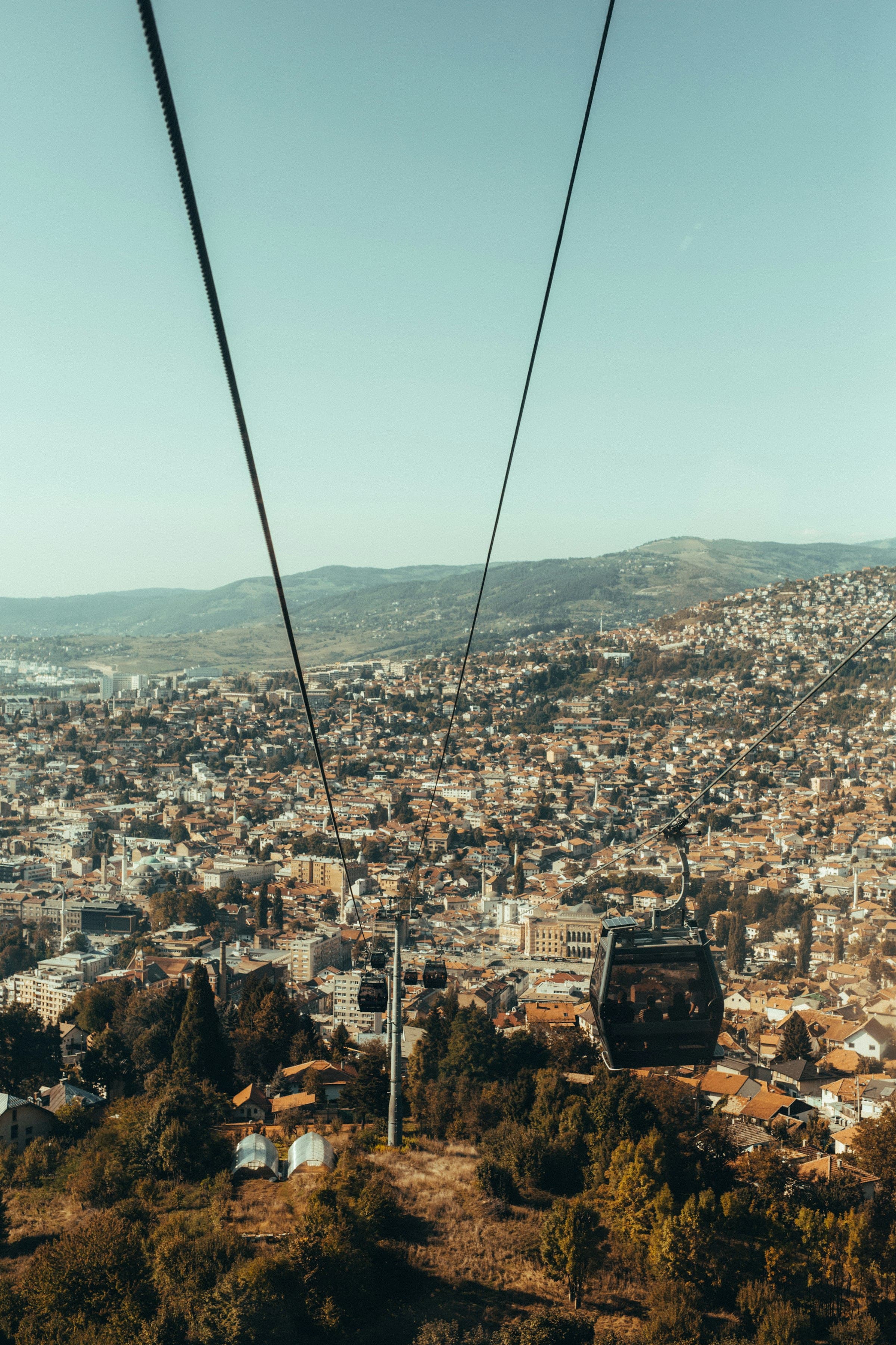 Sarajevo spread across the valley floor and hillsides, seen from the cable car.